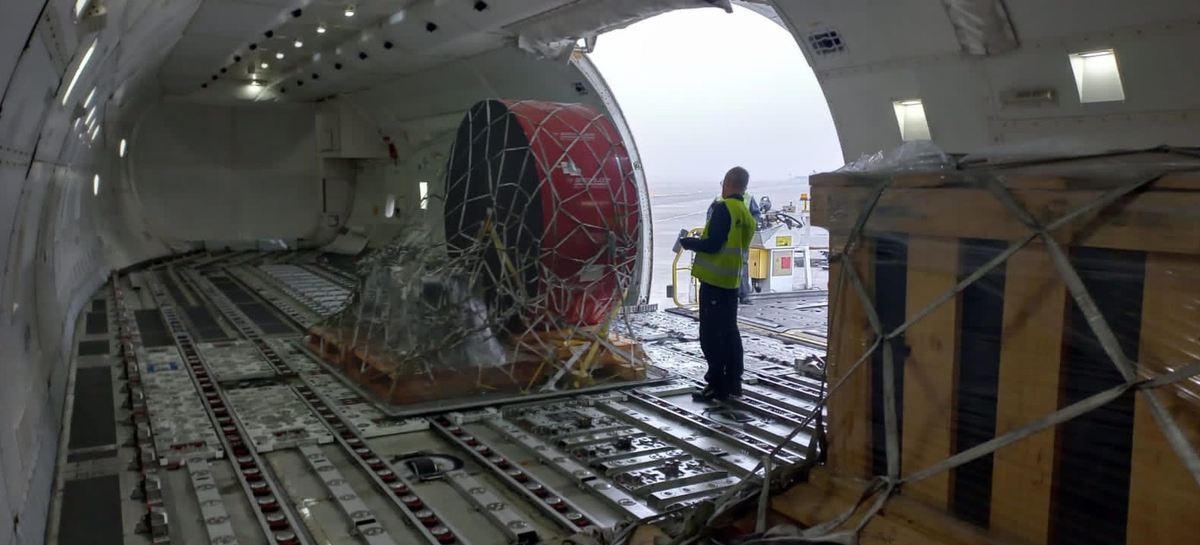 Outsize industrial component secured on the main deck of a freighter aircraft during loading