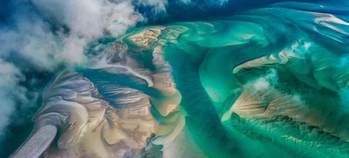 Aerial view of turquoise tidal sandbanks and island channels off the Mozambican coast