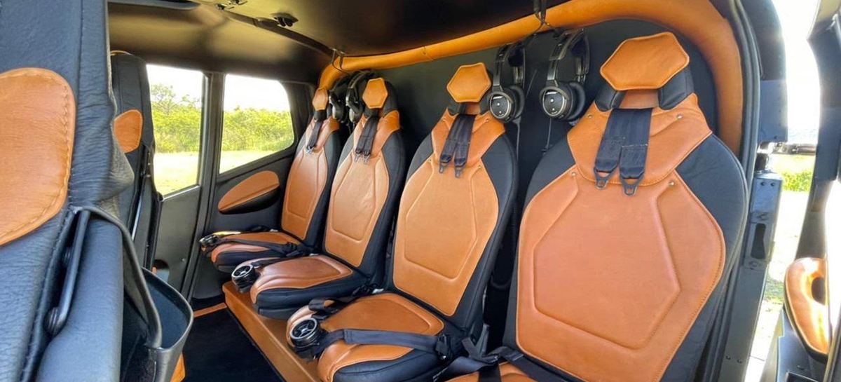 Cabin interior of a charter helicopter, stitched leather seats and headsets set for departure