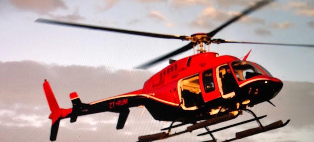 Bell 407 helicopter airborne against an evening sky during an operational sortie