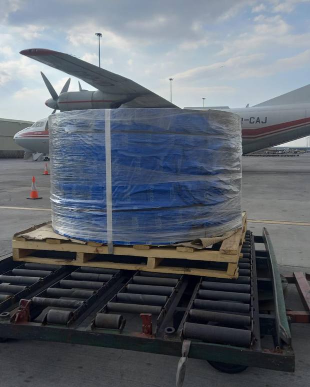 Outsize industrial cargo loaded beside a freighter aircraft in Johannesburg