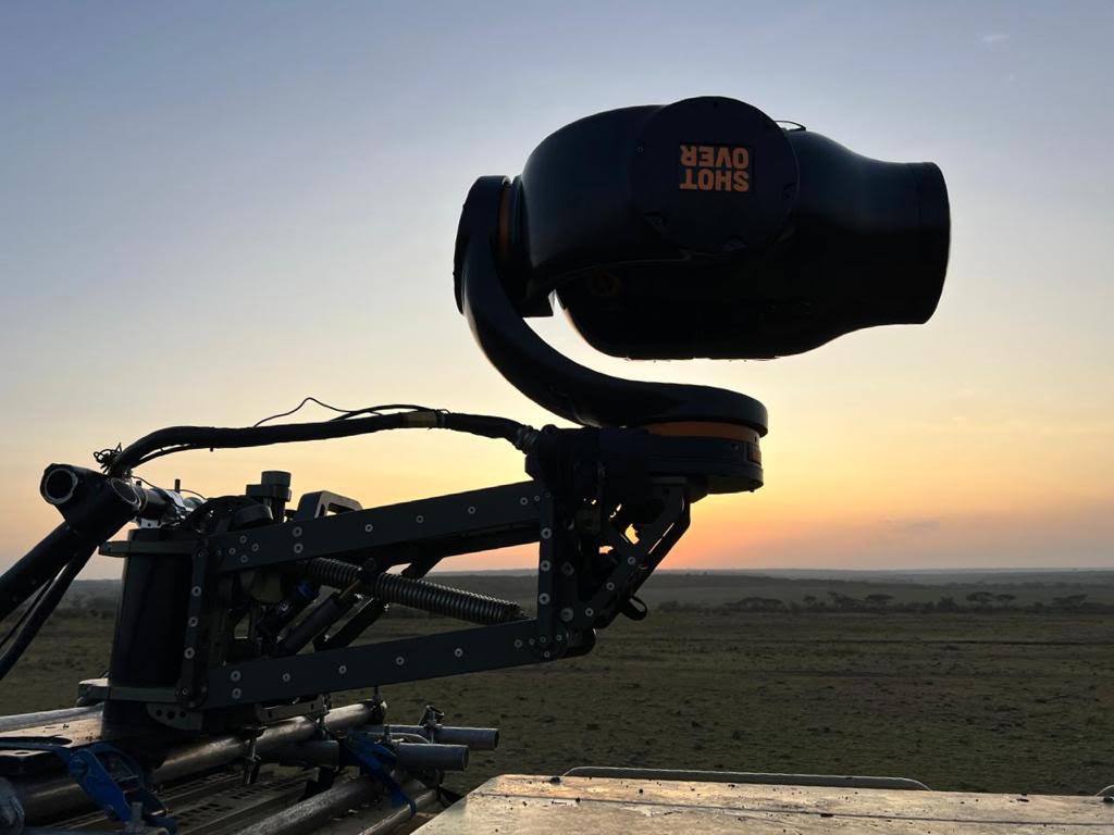 Shotover gyro-stabilised cinema camera gimbal mounted to a helicopter nose at sunrise for aerial filming in Africa